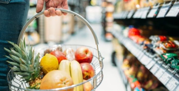 Male customer hand with basket, supermarket