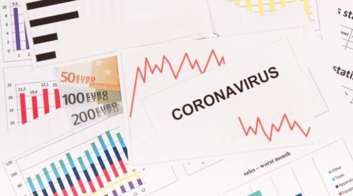 Inscription coronavirus, euro and downward graphs representing financial crisis caused by Covid-19