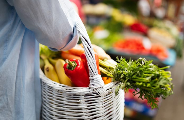 Young woman shopping healthy food on the market