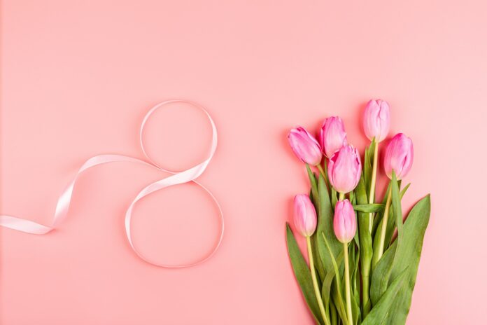 Flat lay of present for Women’s day March 8th on pink background