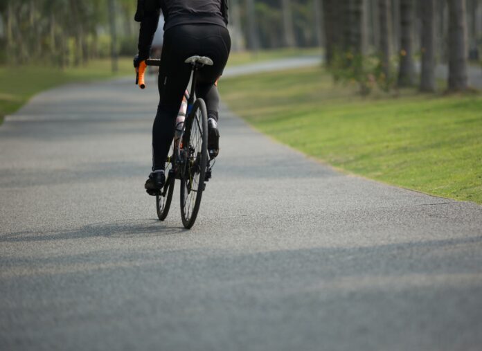 Woman cycling in tropical forest