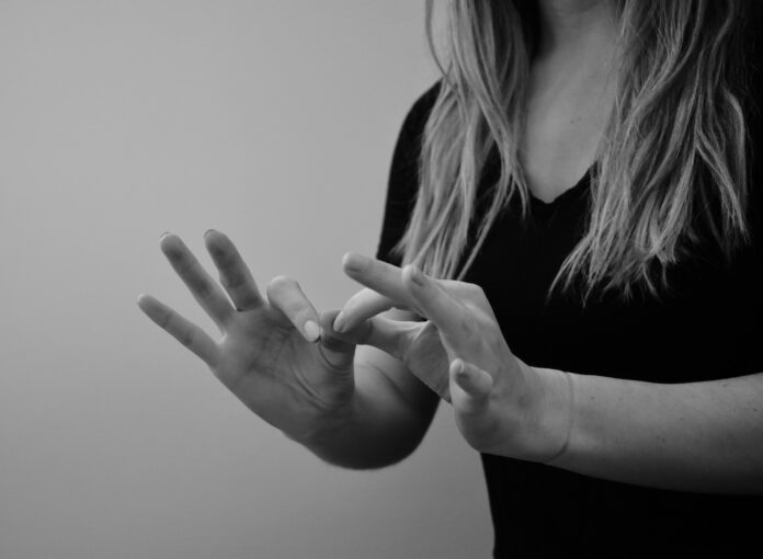 Woman interpreting sign language in black and white