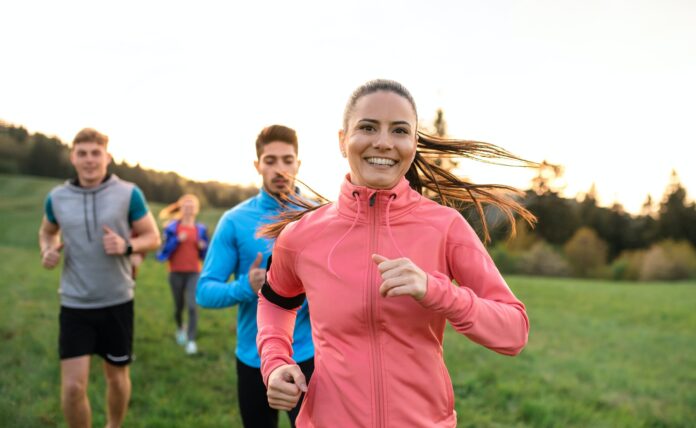 A large group of people cross country running in nature