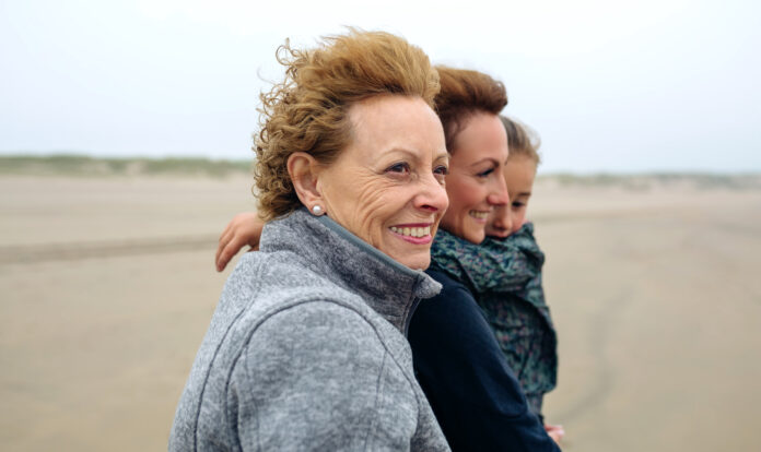 Three generations female walking on the beach